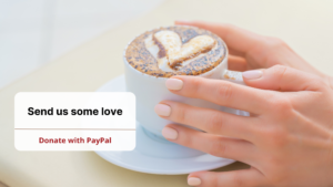 cup of coffee in hands, a heart shape in milk foam